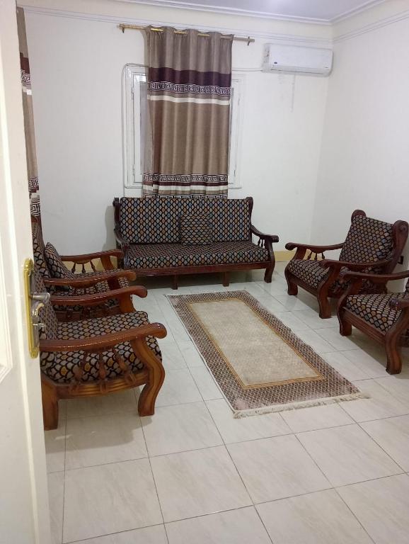 a living room with several chairs and a window at Nour Tours in Cairo