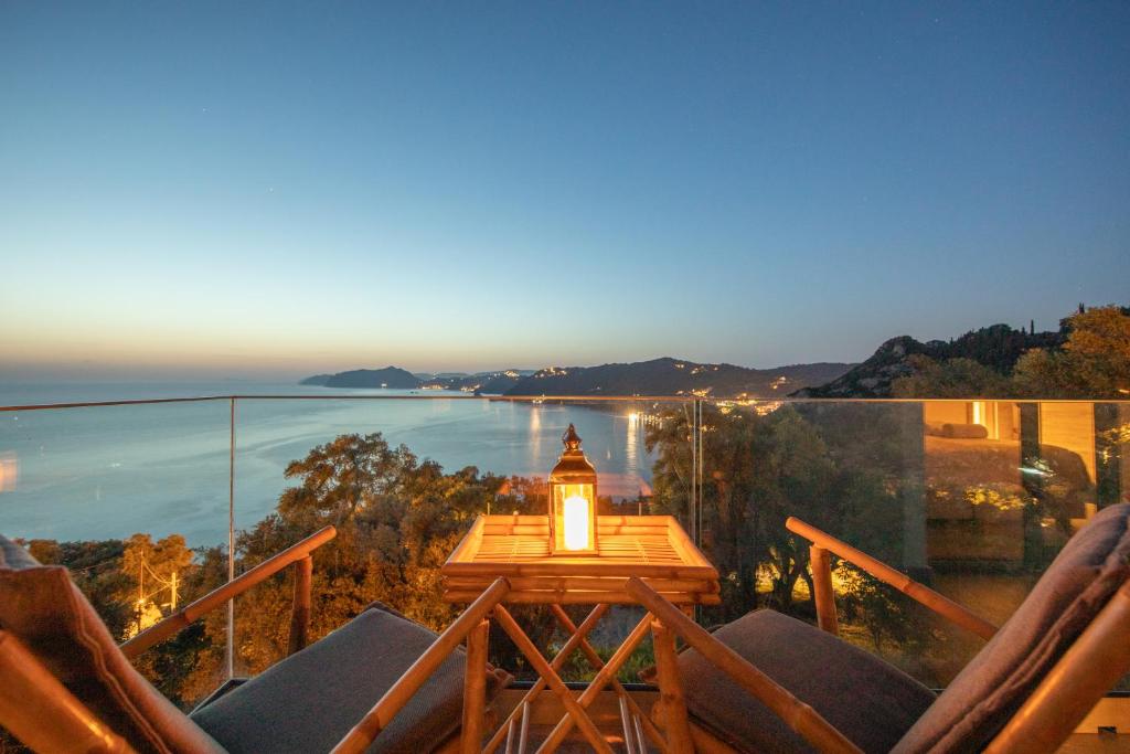 a light on a table on a balcony with the ocean at Irida sunset in Pentátion