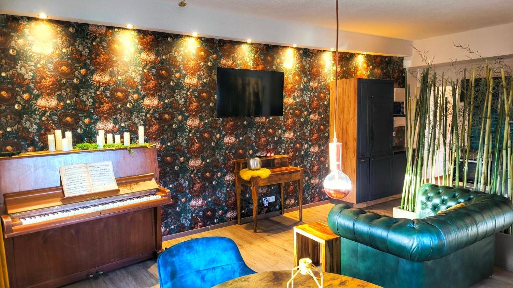 a living room with a piano and a couch at AMORE 69 bei Greta in Marl
