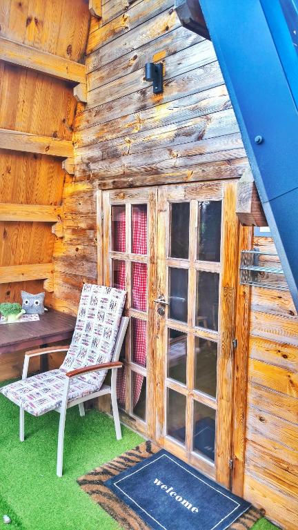 a chair sitting in front of a log cabin at Finnhütte bei GRETA in Marl