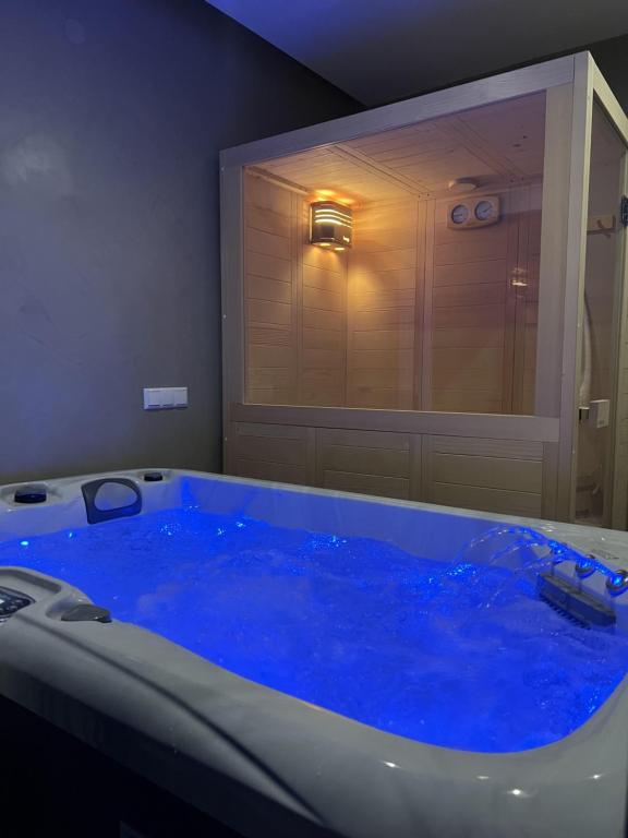 a large blue tub in a bathroom with a window at Nayra View & Spa in Kavála