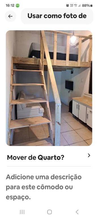 a ladder in a room with a bunk bed at Loft centro do universo in Arroio do Sal