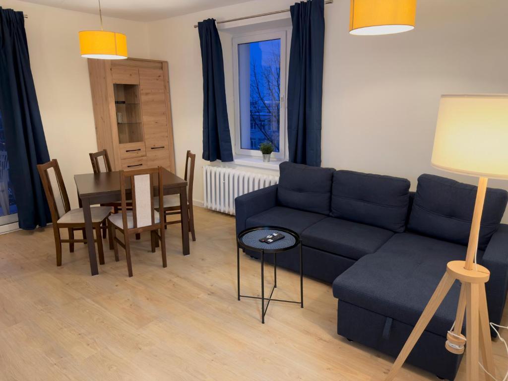 a living room with a couch and a table at Apartament w centrum Konina in Konin