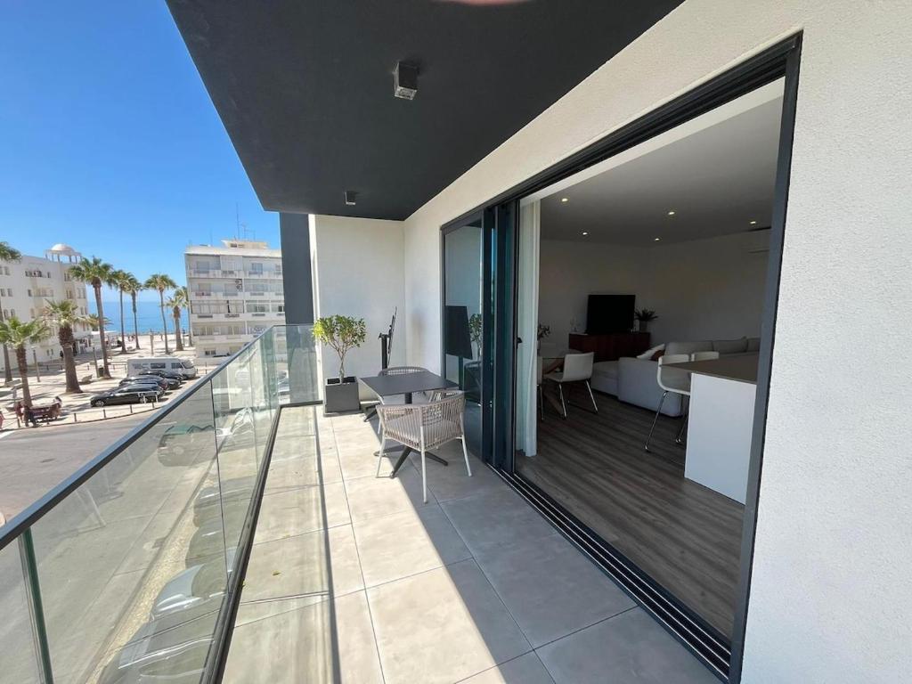 a balcony of a building with a view of a living room at NEW Apartment, Sea Front & Shared Pool in Quarteira