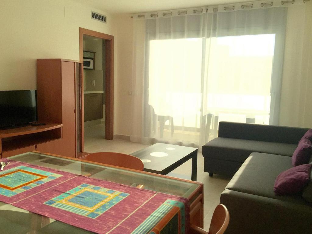 a living room with a couch and a table at Apartment in Estartit with garden in L'Estartit