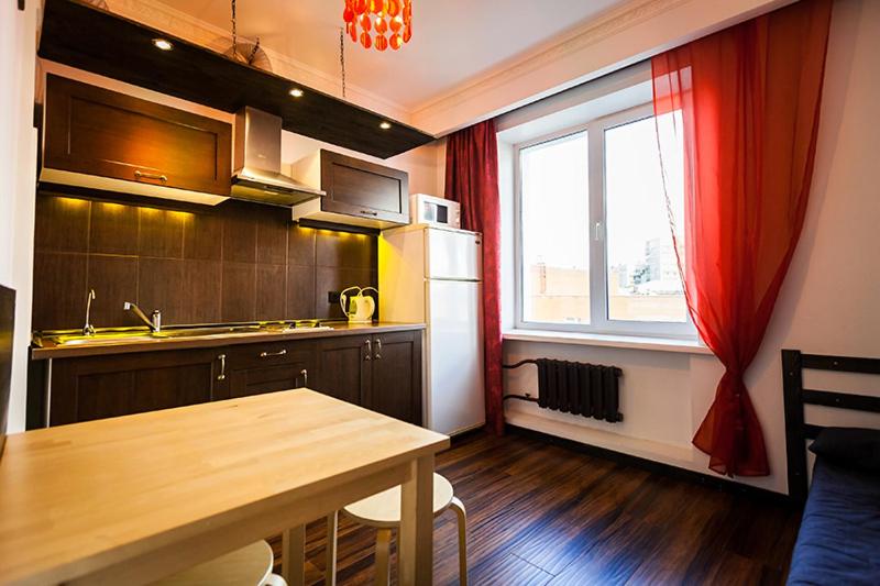 a small kitchen with a table and a window at Apartment on Sibirskaya st. 33 in Novosibirsk