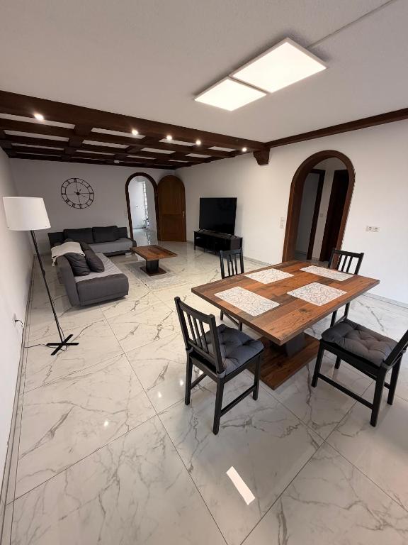 a living room with a wooden table and chairs at TF Schwarzwald in Bad Säckingen