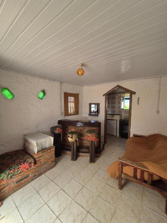 a living room with a couch and a fireplace at Casa Hermena in Santa Vitória do Palmar
