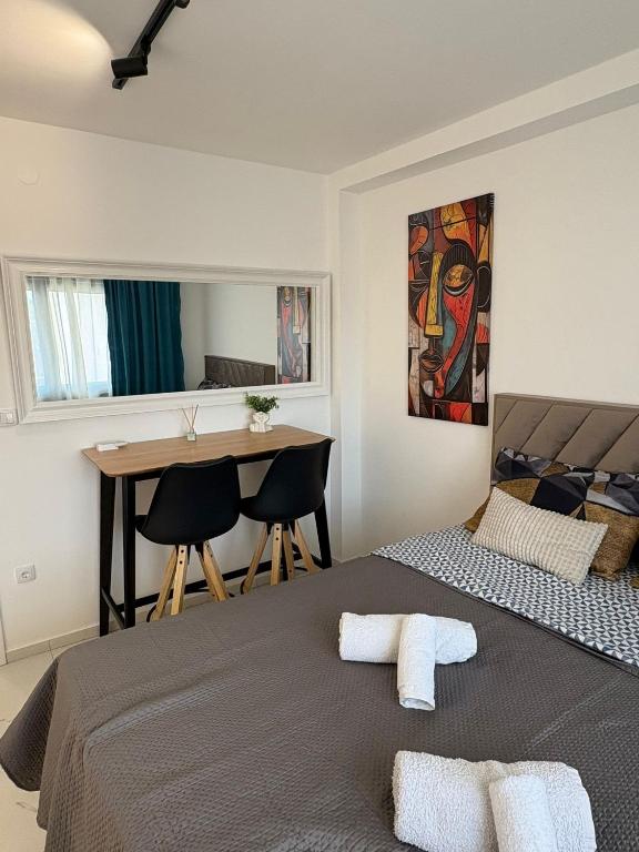 a bedroom with a bed and a desk and a table at Nik 2 in Kruševac