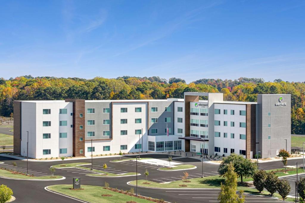 a large white building with a parking lot at Element by Marriott Opelika Auburn in Opelika