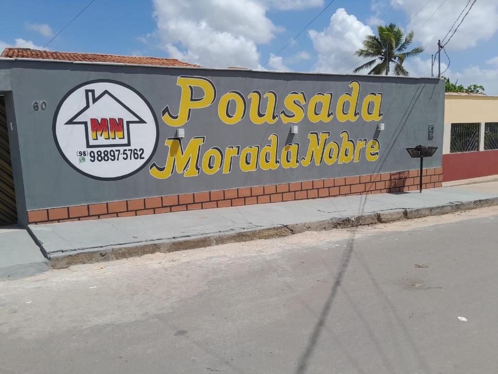 a sign for a pueblo morocco store on a street at Pousada Morada Nobre in Barreirinhas