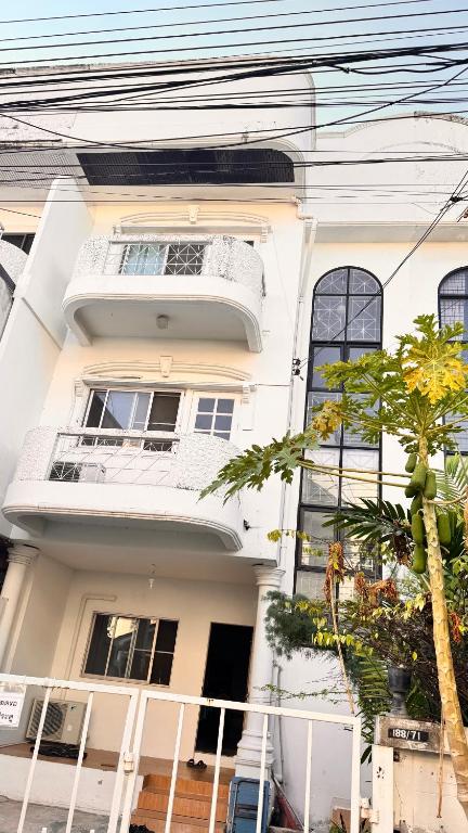 a white house with a tree in front of it at Bangkok villa with 3 bedrooms in Ban Zong Katiam