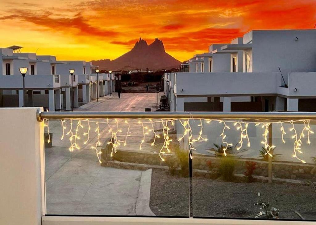 a view of a mountain from a balcony with lights at Sunset Point San Carlos in San Carlos
