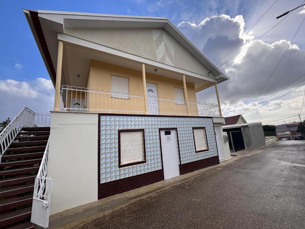a blue and white building with a balcony at Refugio do Alto de Levira in Anadia