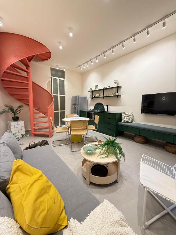 a living room with a couch and a table at Beit'roun 2BR Apartment in Batroun in Batroûn