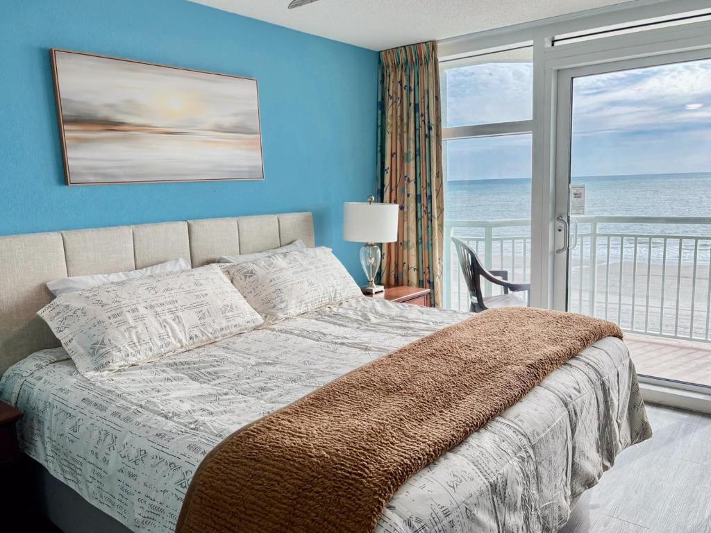 a bedroom with a bed with a view of the ocean at Amazing Oceanfront Home HS 4th Floor in Myrtle Beach