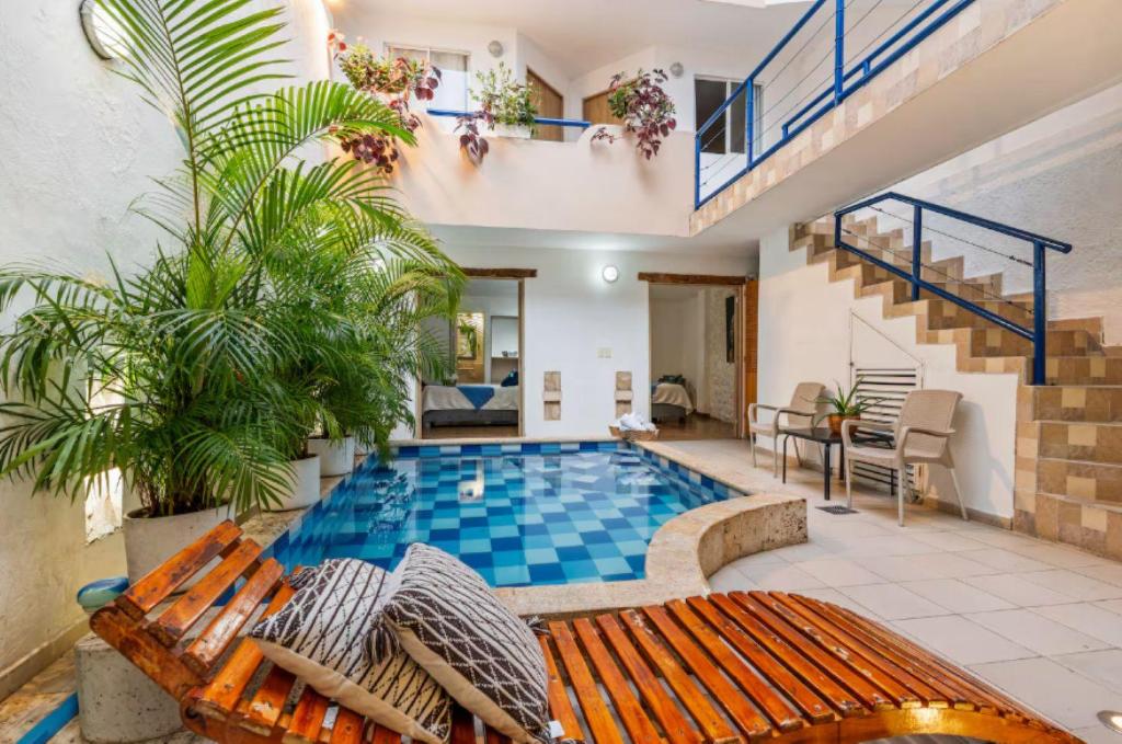 a swimming pool in the middle of a house at Casa Payis Hotel in Cartagena de Indias