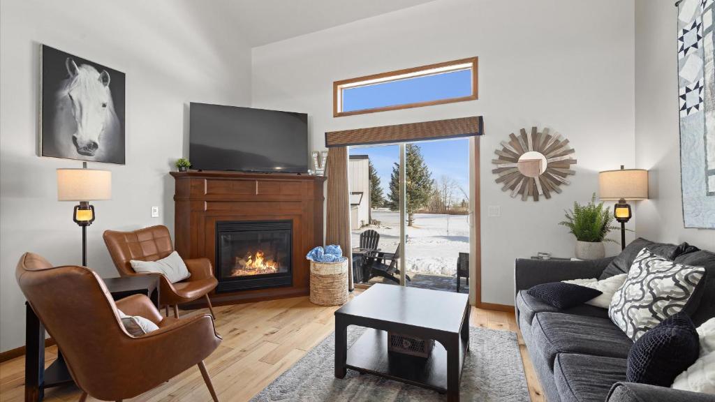 a living room with a couch and a fireplace at Altitude Adjustment in Red Lodge