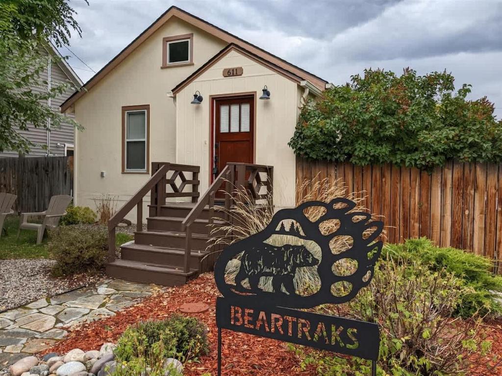 a sign in front of a house with a bear paws sign at Beartraks in Red Lodge