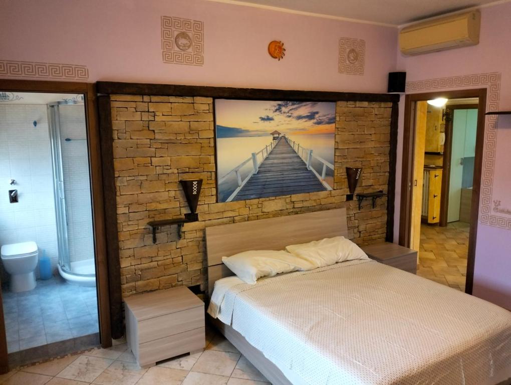 a bedroom with a bed with a painting on the wall at Residence Future in Cologno Monzese