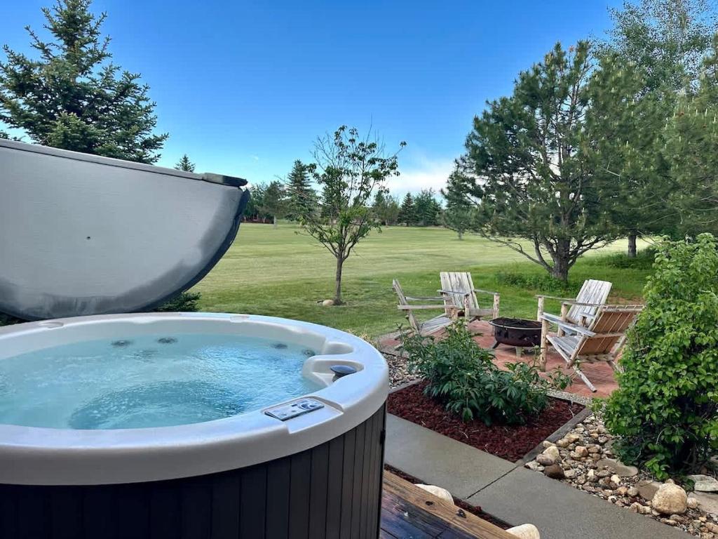 a large bath tub in a yard with a boat at Sans Souci Cabin in Red Lodge