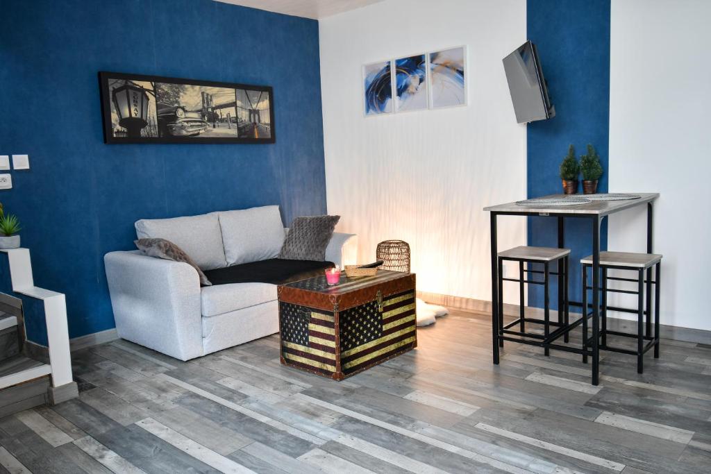 a living room with a couch and a table at République Le Nid Douillet in Saint-Dizier