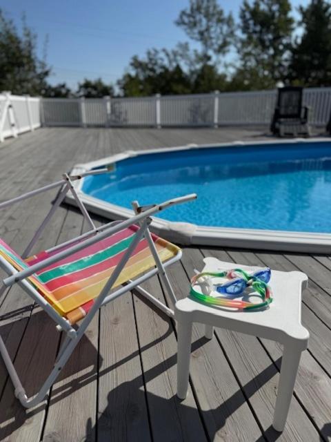 a chair sitting on a deck next to a swimming pool at Ditt feriehjem! in Kristiansand