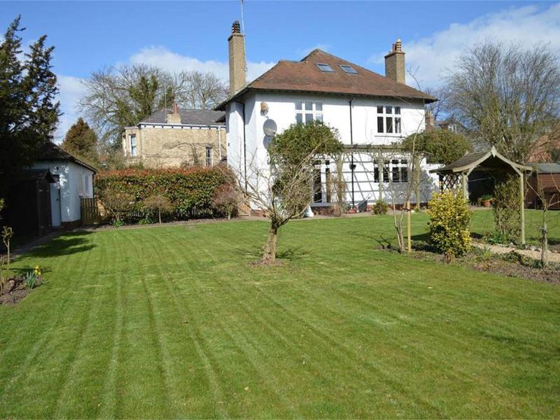 a large white house with a large grass yard at Boutique Rooms at The Ellesmere in Hornsea