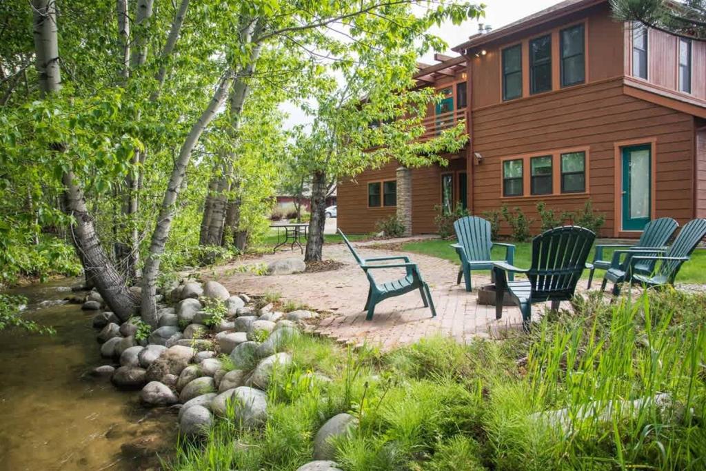 a group of chairs sitting on a patio in front of a house at Mountain Treetop in Red Lodge