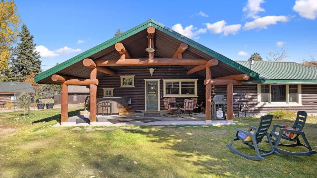 a log cabin with a gazebo and two chairs at Rendezvous Lodge in Red Lodge