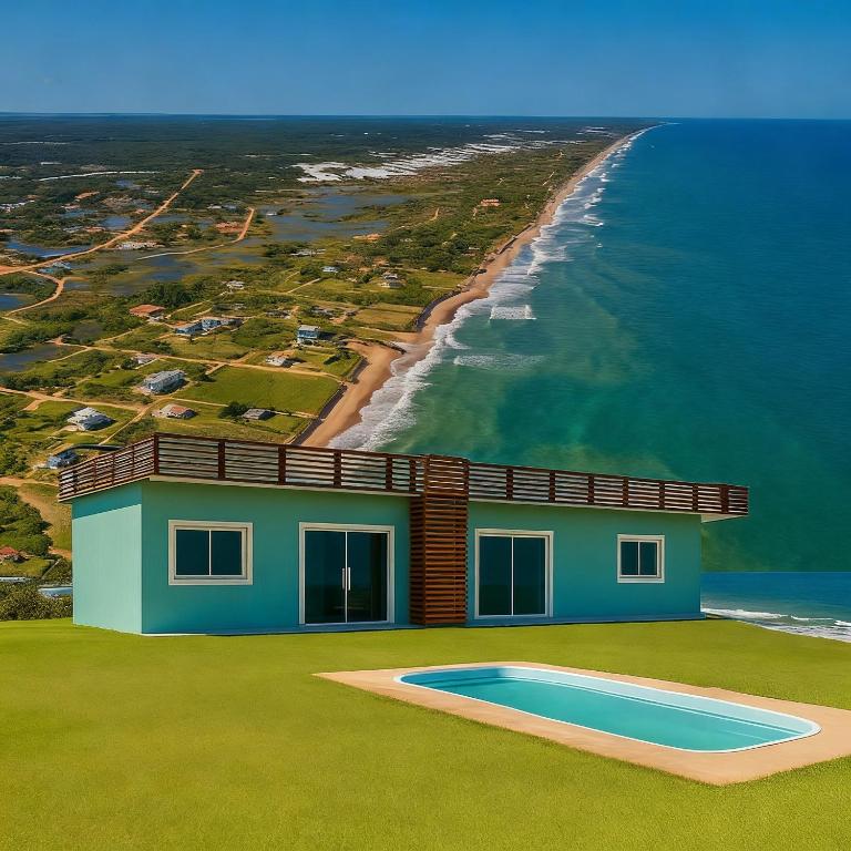 a house with a swimming pool next to the ocean at Village Sauipe Praia & Lagoa - Dentro de Condomínio in Porto de Sauipe