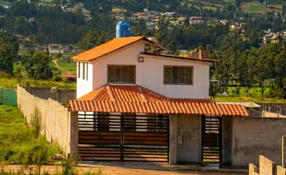 a small white house with an orange roof at Casa Blanca Andina in Cajamarca