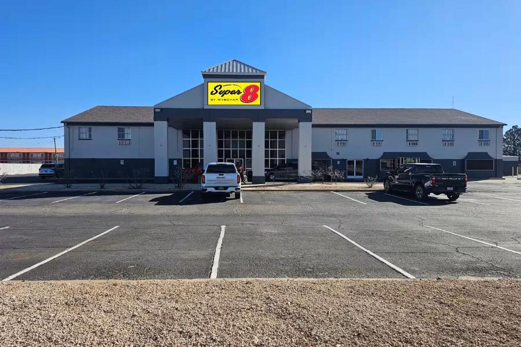 a mcdonalds restaurant with a car parked in a parking lot at Super 8 by Wyndham Hobbs in Hobbs