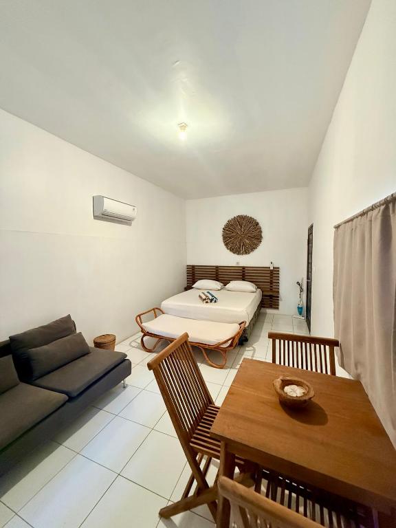 a living room with a bed and a couch at Solara Gili Air in Gili Islands