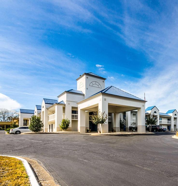 a large white building with a clock tower on it at EXPRESS INN Troy in Troy