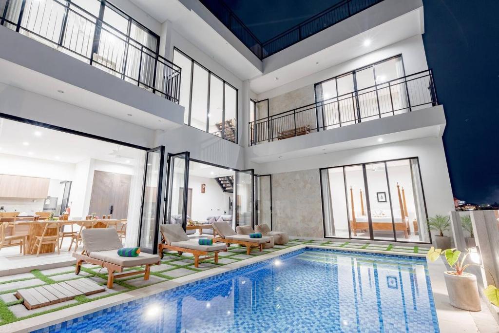 a house with a swimming pool and a living room at Zen Villa - Central Canggu in Canggu