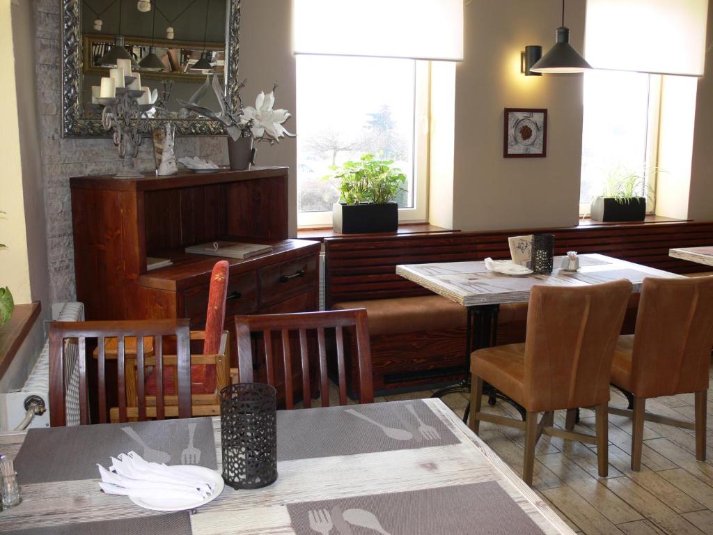 a dining room with two tables and chairs and a table and chairsktop at Hotel Na Baste in Jablonec nad Nisou