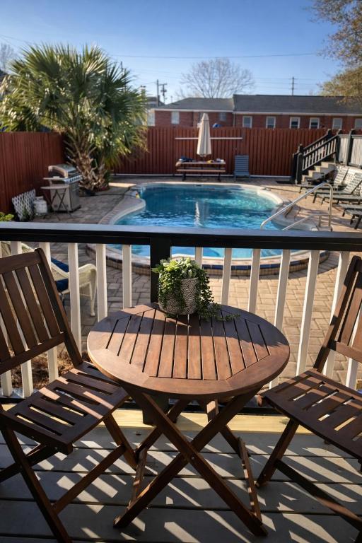 a table and two chairs and a swimming pool at Relaxing Poolside Condo in Savannah