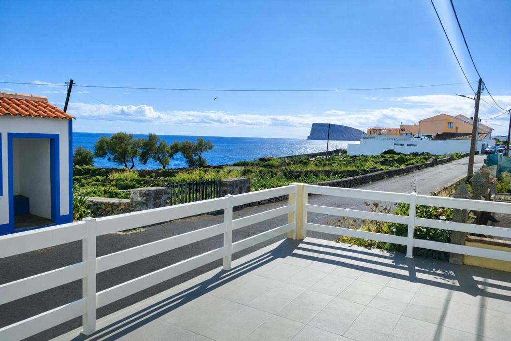 a view of the ocean from the balcony of a house at Alojamento dos cagarros in São Sebastião