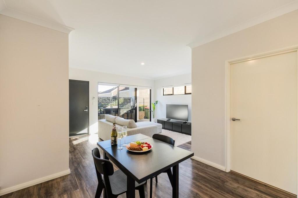 a living room with a table and a couch at 9 by the Beach in Rockingham