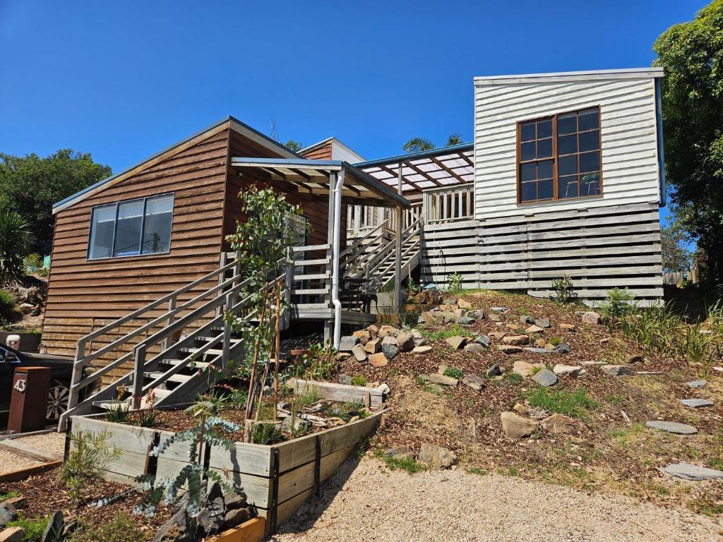 a house with a garden in front of it at Cedar Hill Retreat in Venus Bay