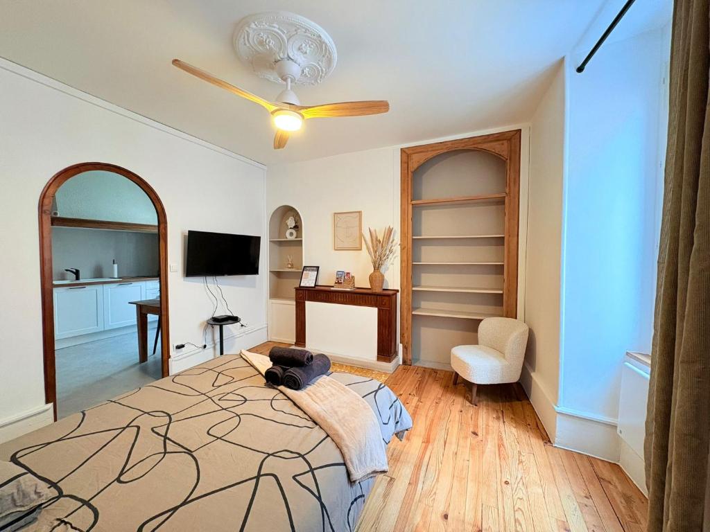 a bedroom with a bed and a ceiling fan at La Parenthèse à Foix in Foix