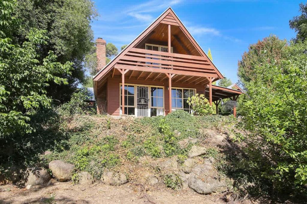 a small house sitting on top of a hill at The Nest Rustic Lodge-Style Hideaway in Beechworth