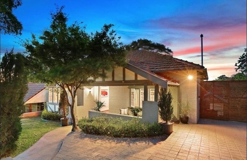 a house with a tree in front of it at Central Chatswood Urban Stay in Sydney