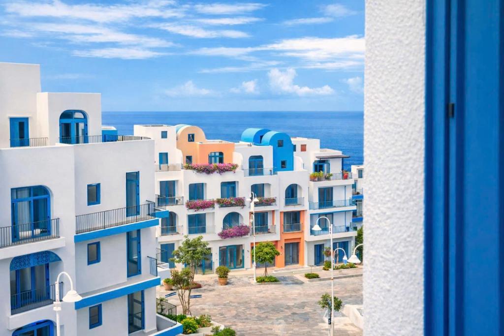 a view of a building with the ocean in the background at L'amina Thom Hotel in Kon Rung (1)