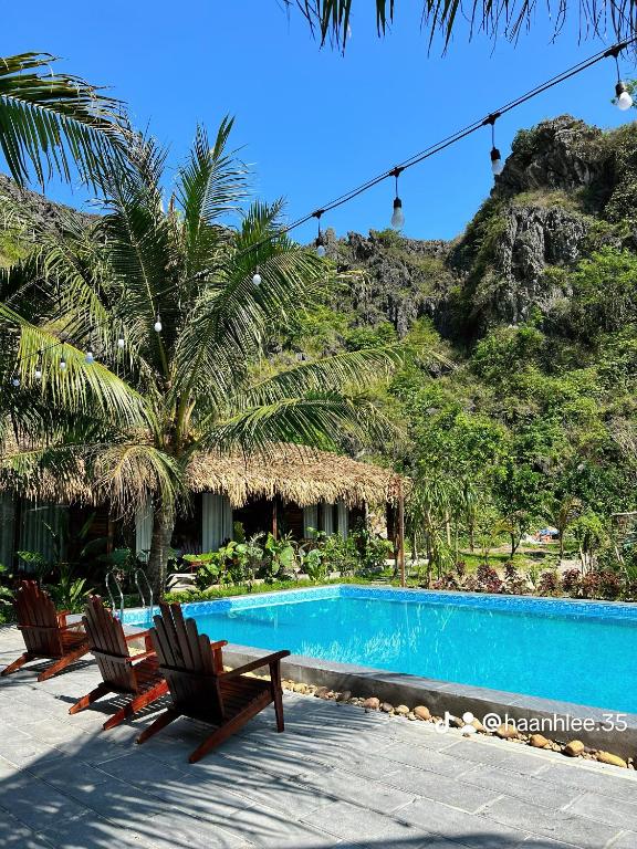a resort with a swimming pool and two chairs at Peaceful Garden Tam Cốc in Ninh Binh