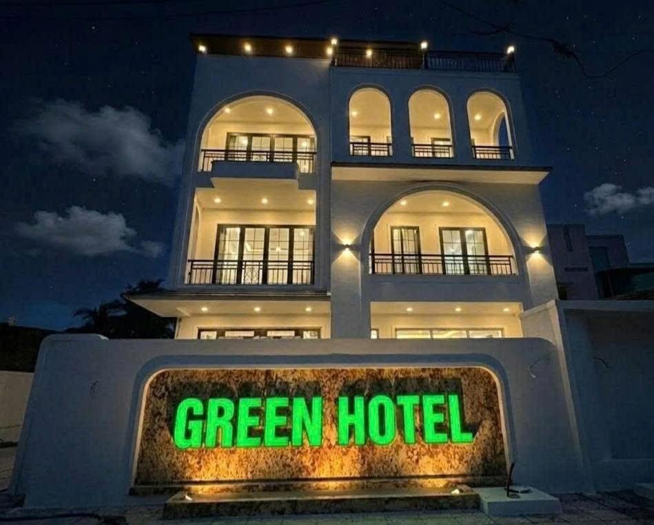 a green hotel sign in front of a building at Green Hotel in Khánh Dương