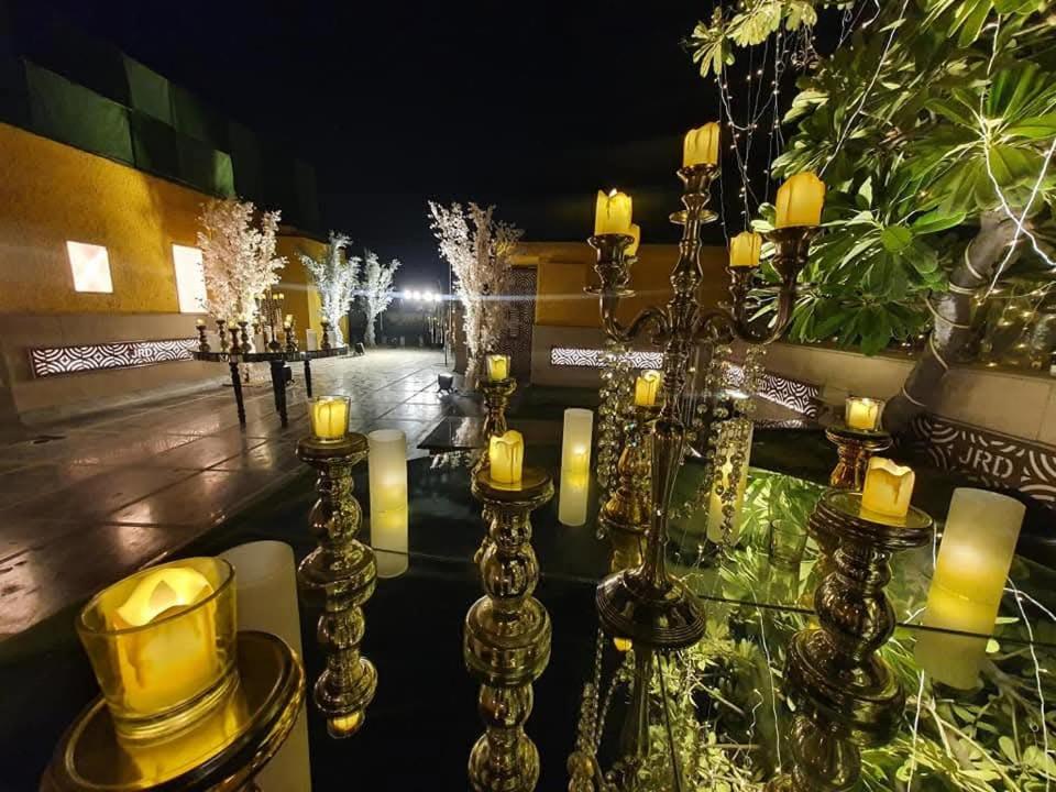 a group of candles and candlesticks on a street at night at JRD Luxury-Business Hotel in New Delhi