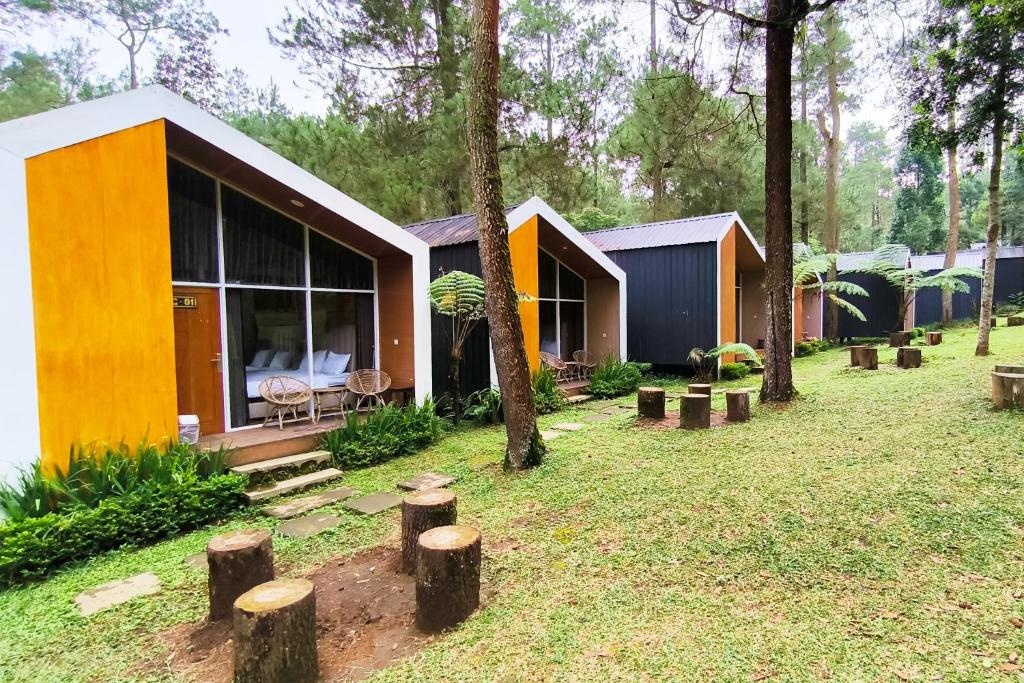 a house in the middle of a yard with trees at Spekta Merbabu powered by Cocotel in Jlarem