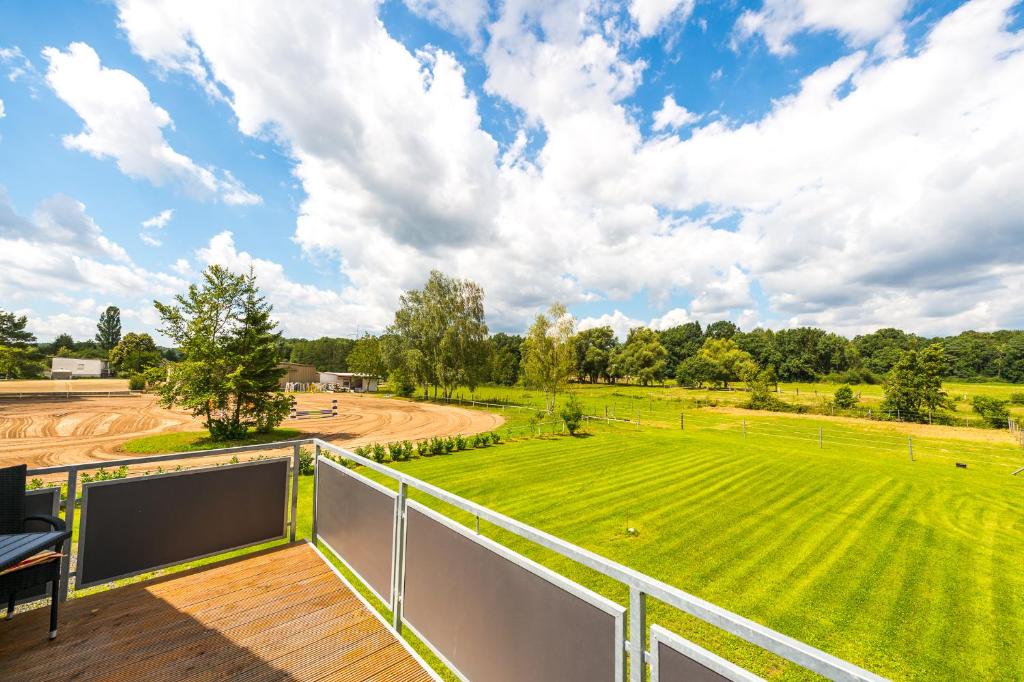 a balcony with a view of a green field at Ferienwohnung Schantz in Roßdorf